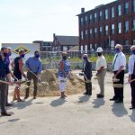 image of people holding shovels full of dirt